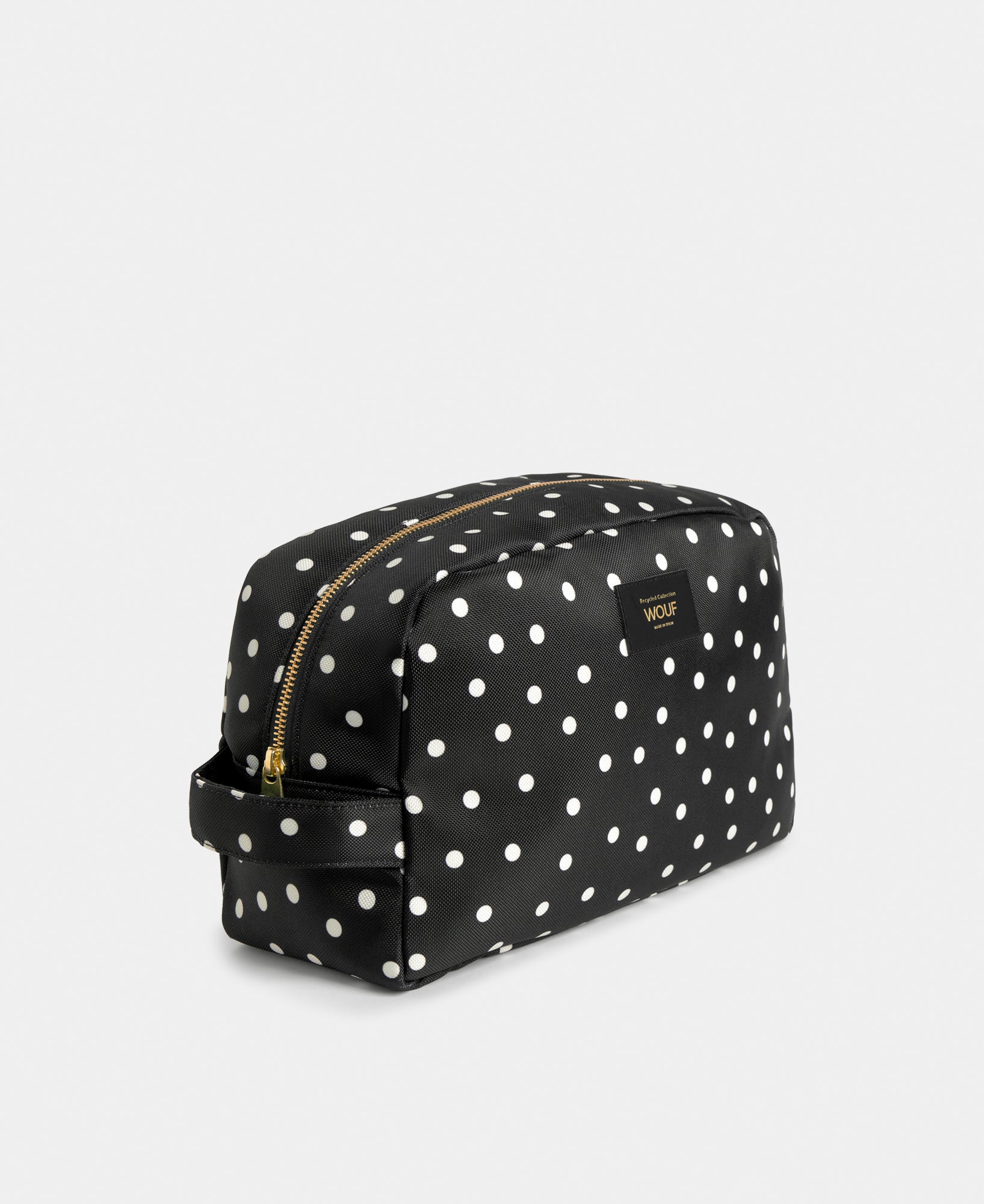 Side view of the Grace large toiletry bag with white polka dot print on a black background - Wouf