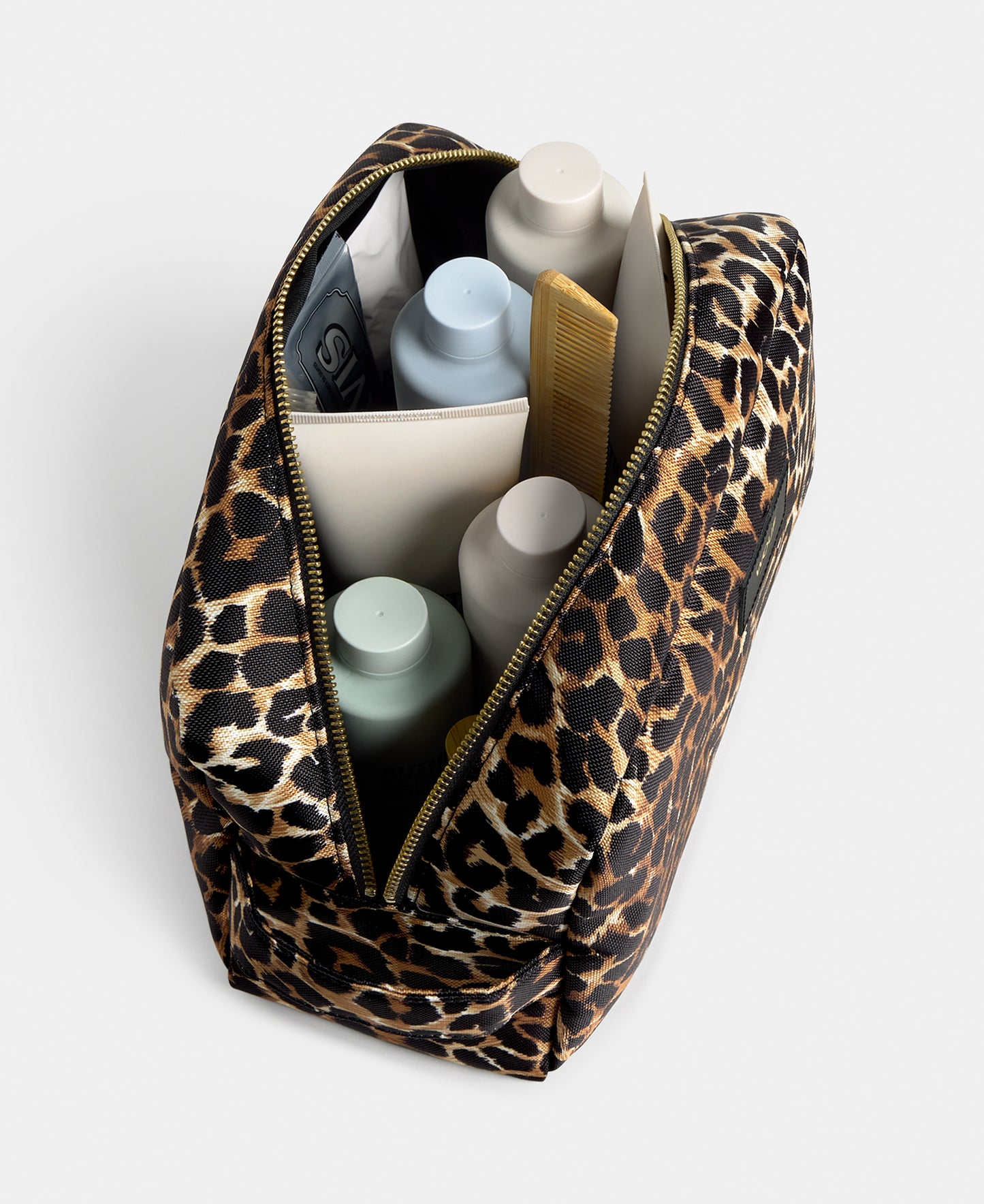 Interior detail of the Icon large toiletry bag with black and brown leopard print - Wouf