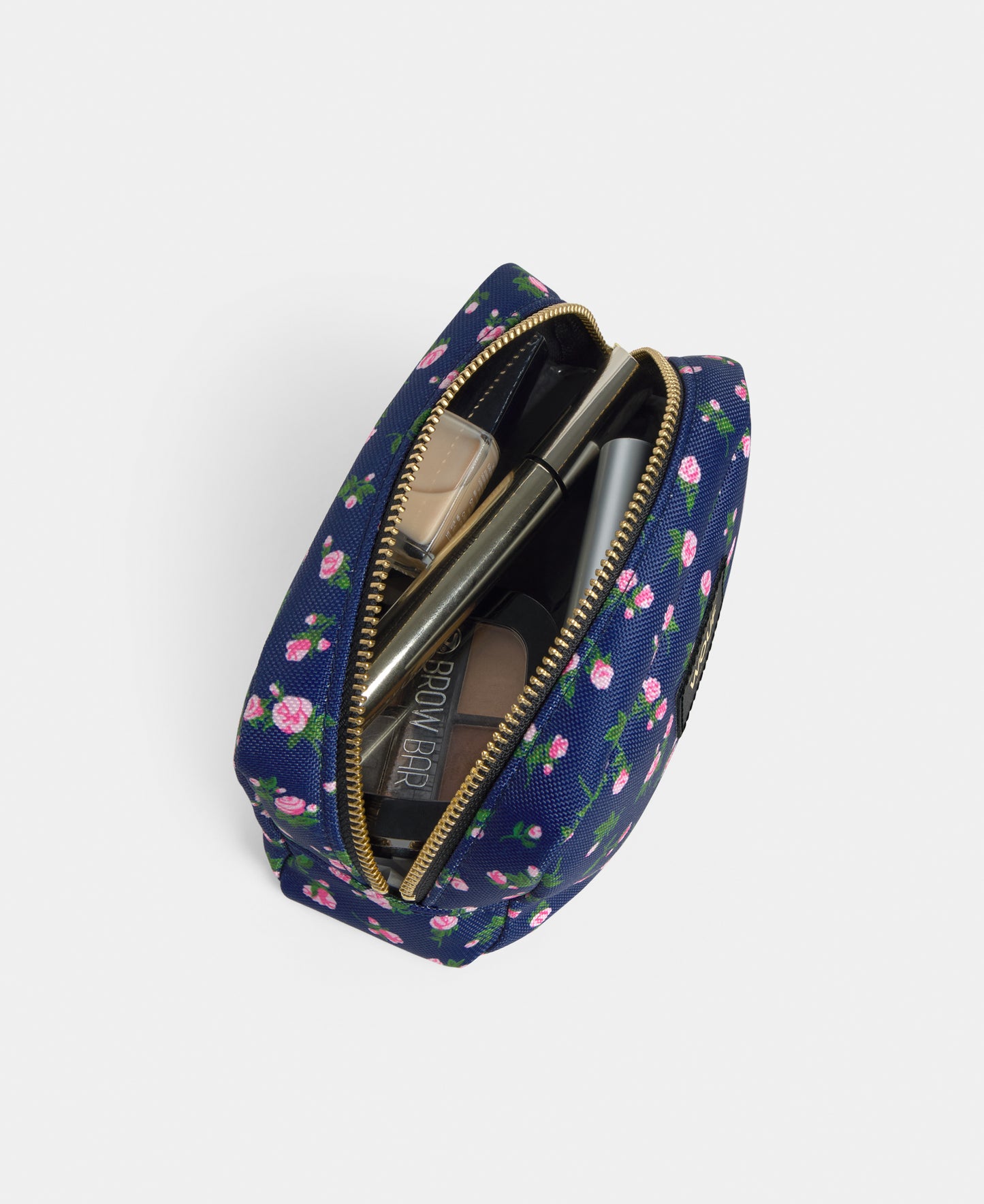 Interior detail of the Edith makeup bag with pink and green floral print on a navy background - Wouf