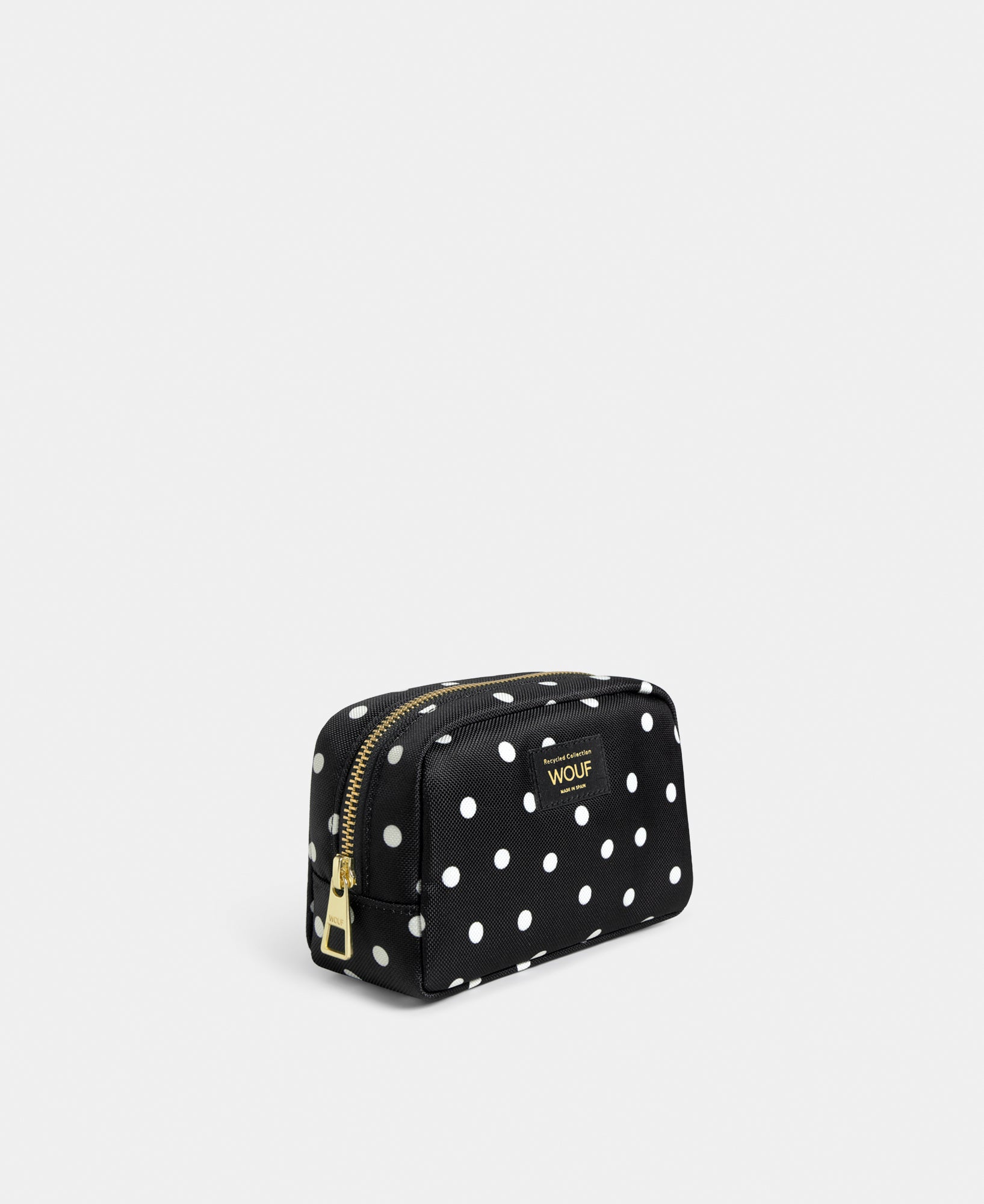 Side view of the Grace makeup bag with white polka dot print on a black background - Wouf