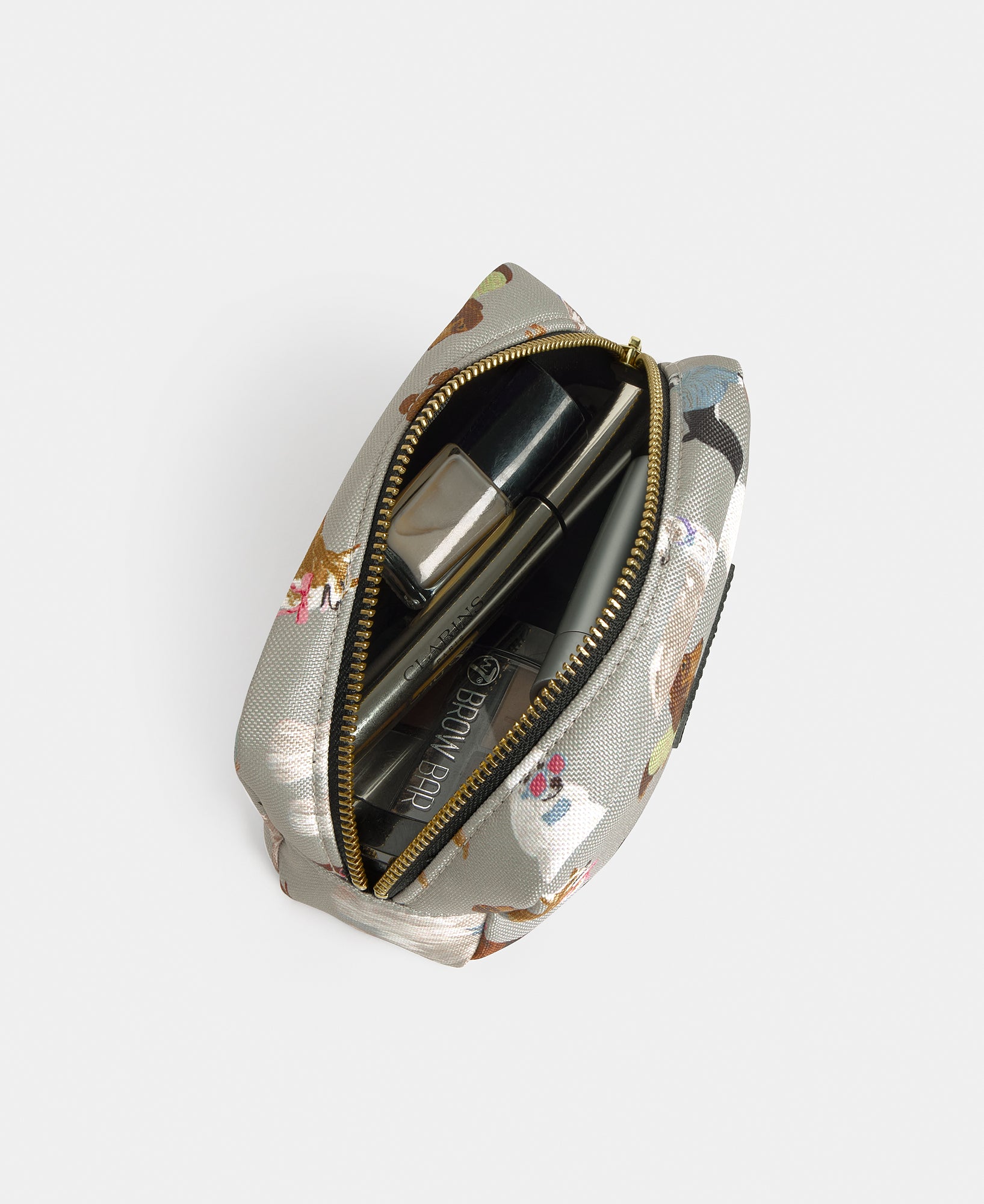 Interior detail of the Puppy makeup bag with multicolour dog print on a grey background - Wouf