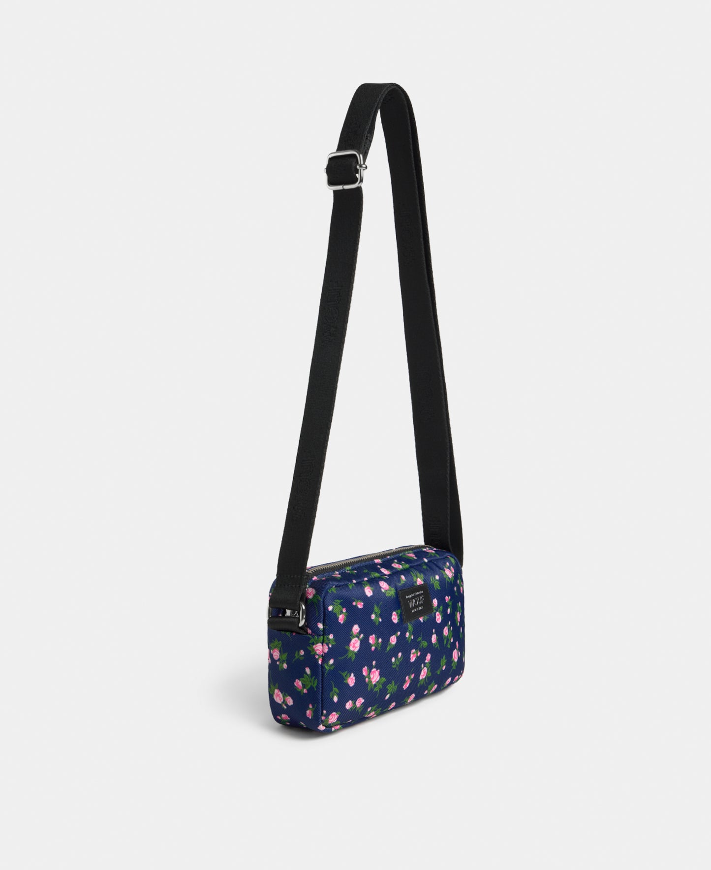 Side view of the Edith mini crossbody bag with pink and green floral print on a navy background - Wouf