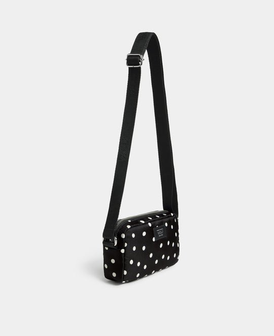 Vue latérale de le mini sac bandoulière Grace à pois blancs sur fond noir - Wouf