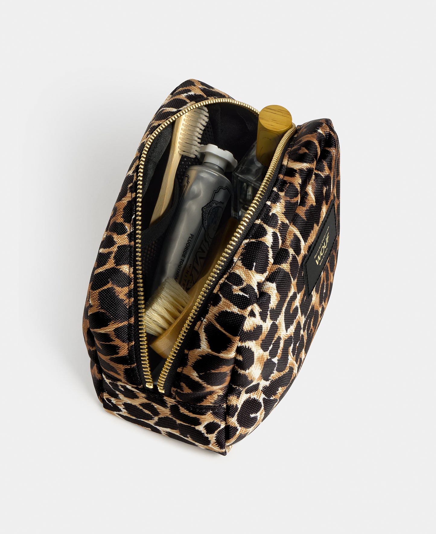 Interior detail of the Icon toiletry bag with black and brown leopard print - Wouf