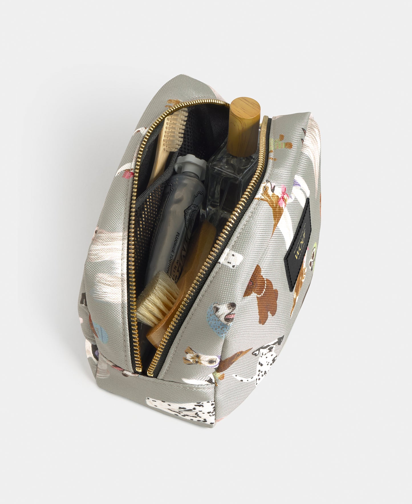 Interior detail of the Puppy toiletry bag with multicolour dog print on a grey background - Wouf