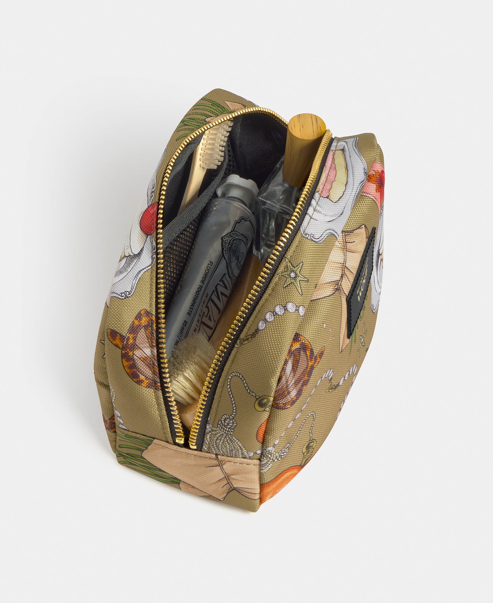 Interior detail of the Tender toiletry bag with multicolour illustrated print on a khaki background - Wouf