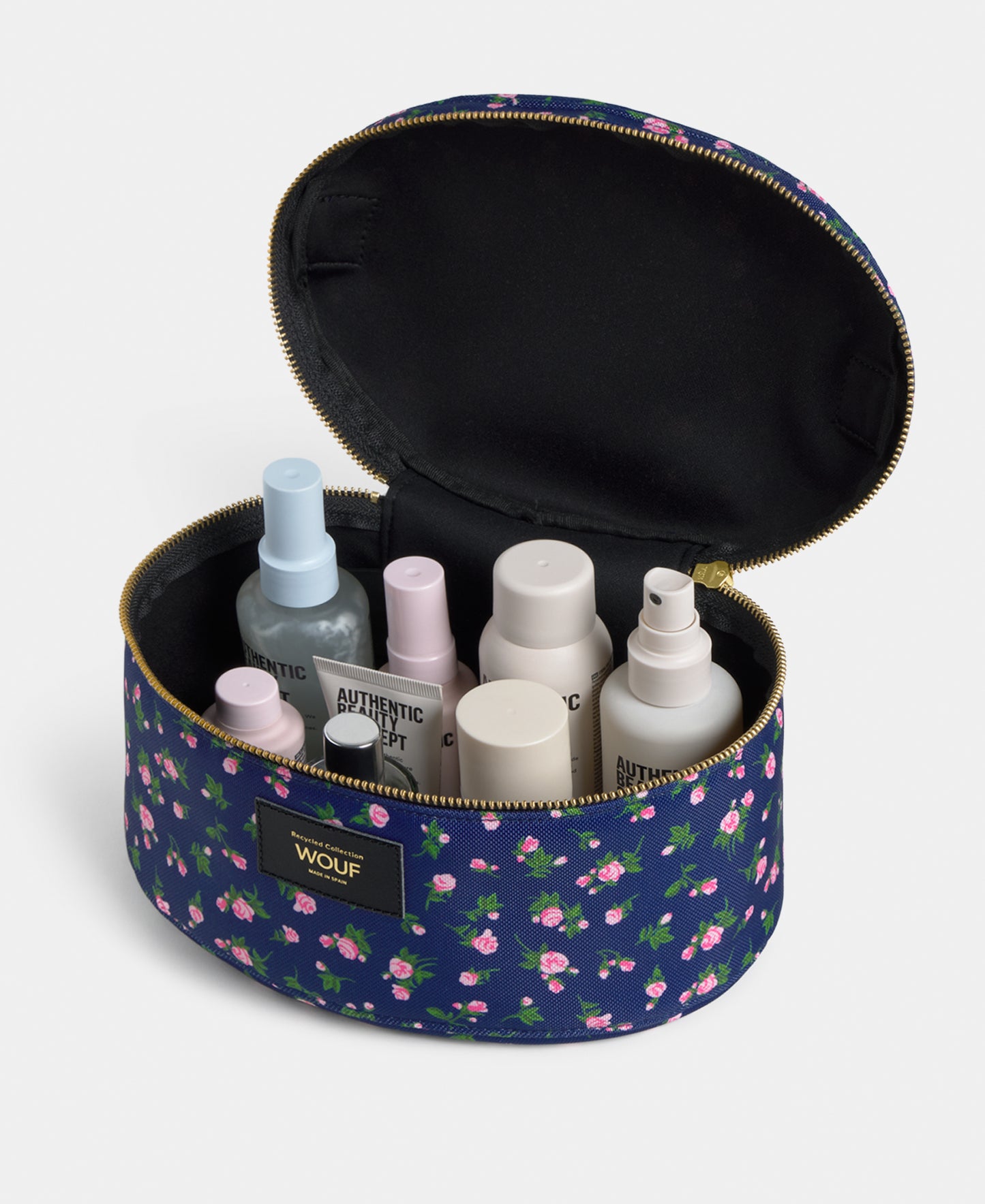 Interior detail of the Edith vanity bag with pink and green floral print on a navy background - Wouf