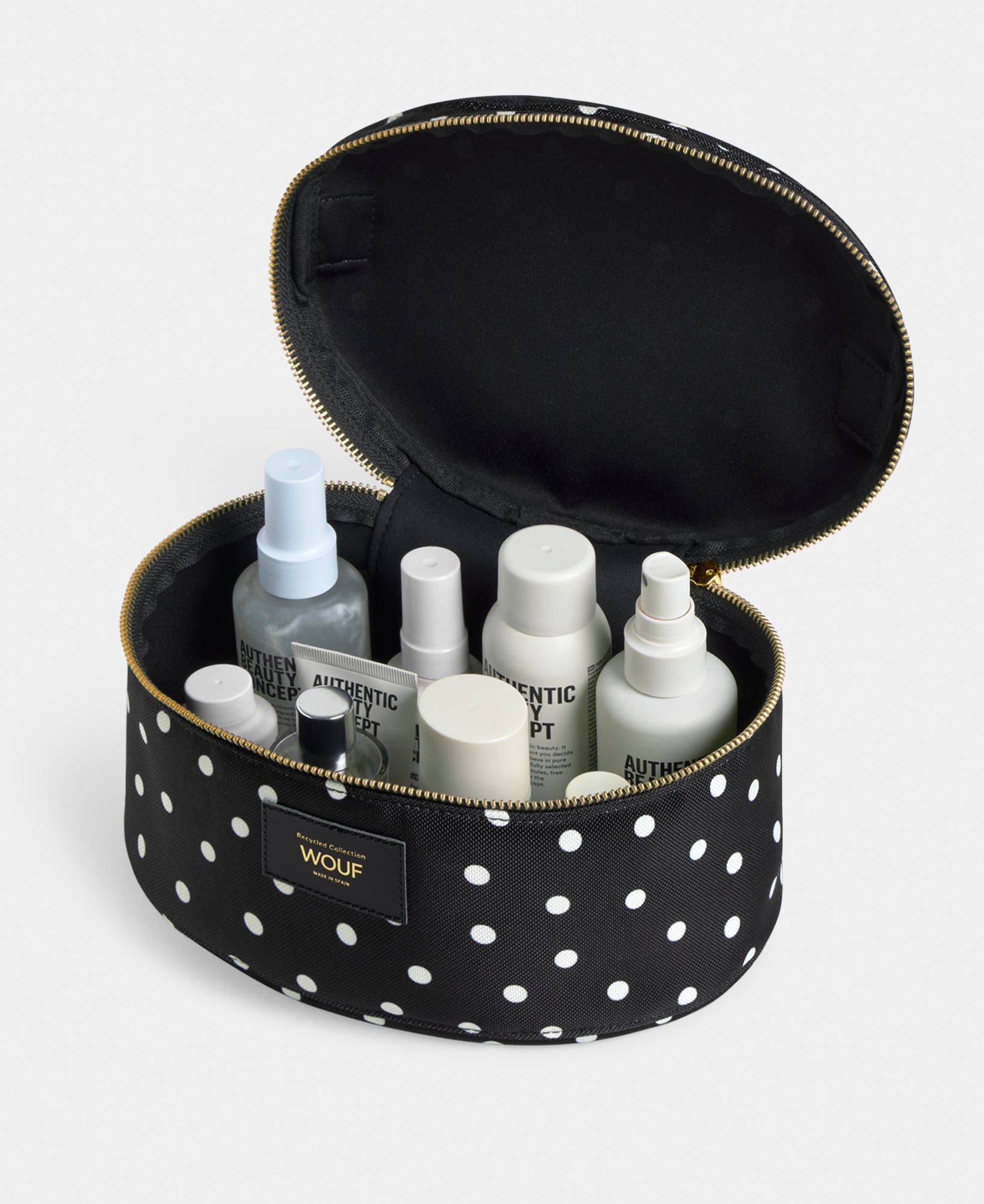 Interior detail of the Grace vanity bag with white polka dot print on a black background - Wouf