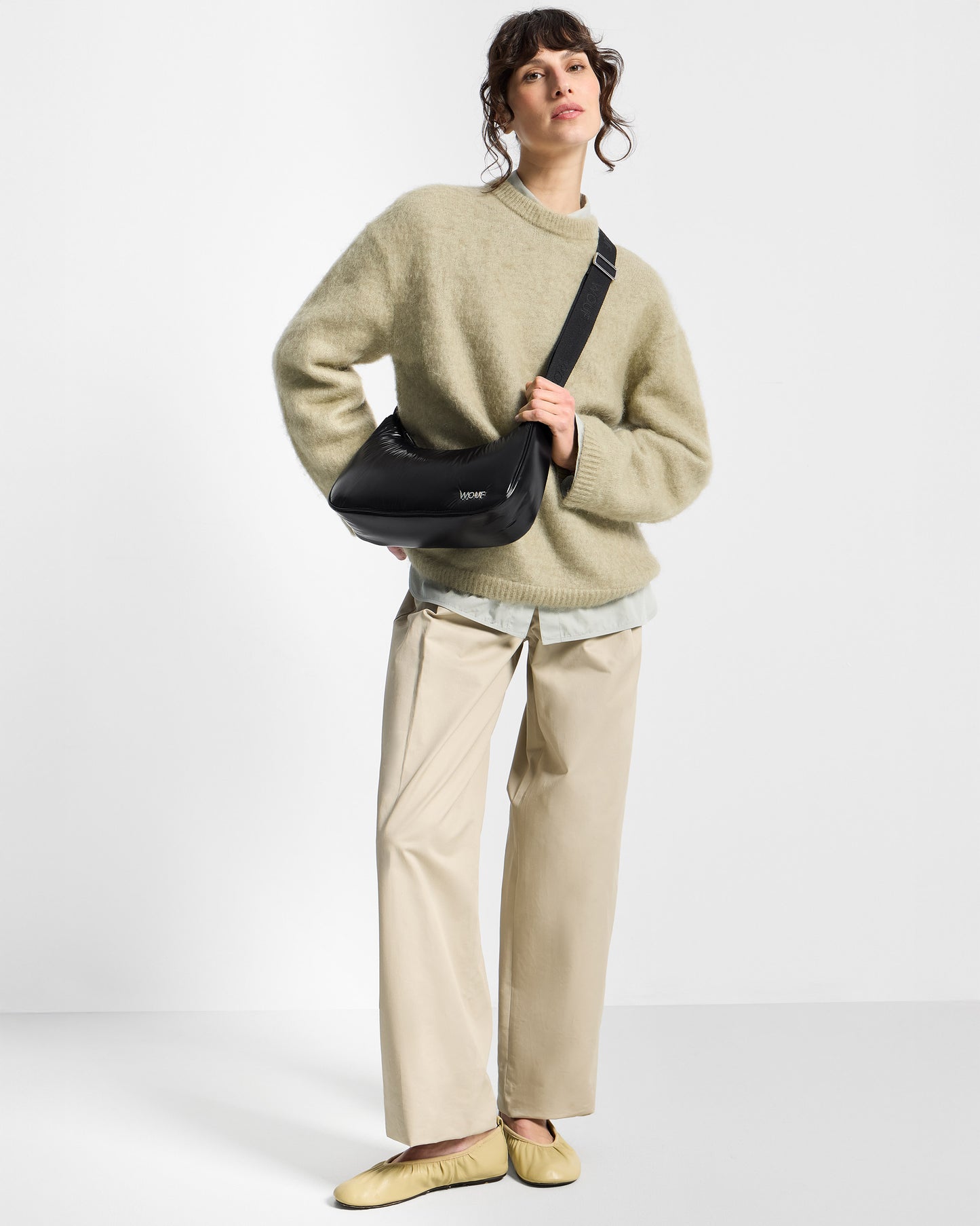 Model with crossbody Bag black colour with a shiny finish - Wouf