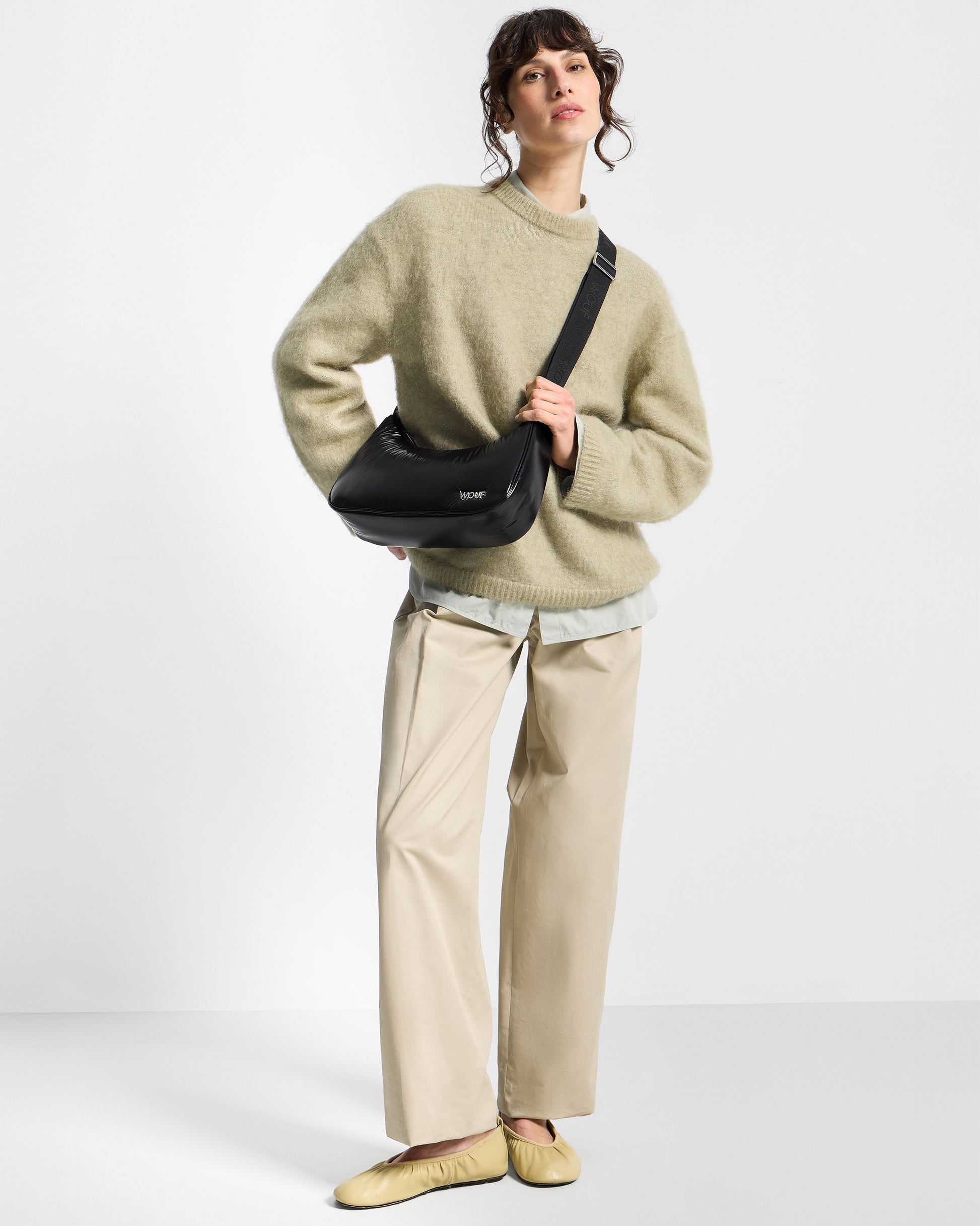 Model with crossbody Bag black colour with a shiny finish - Wouf