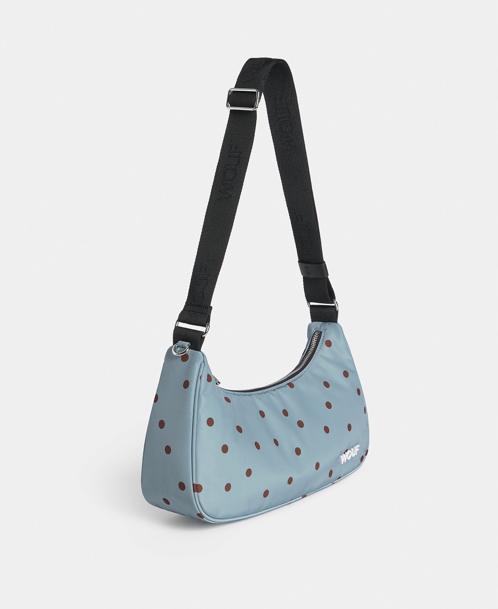 Side view of the crossbody bag with brown polka dots on a light blue background - Wouf