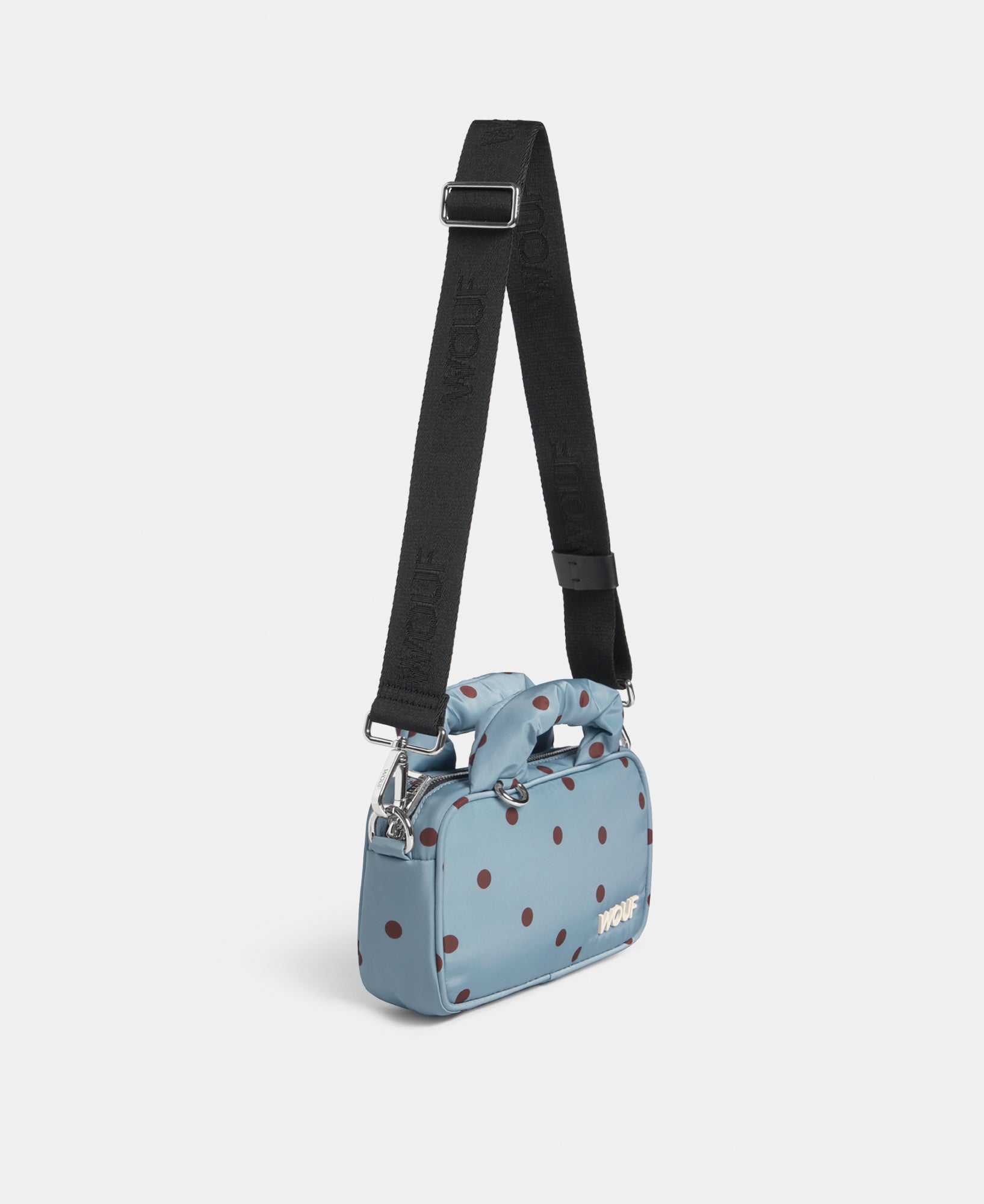 Side view of the mini bag with brown polka dots on a light blue background - Wouf