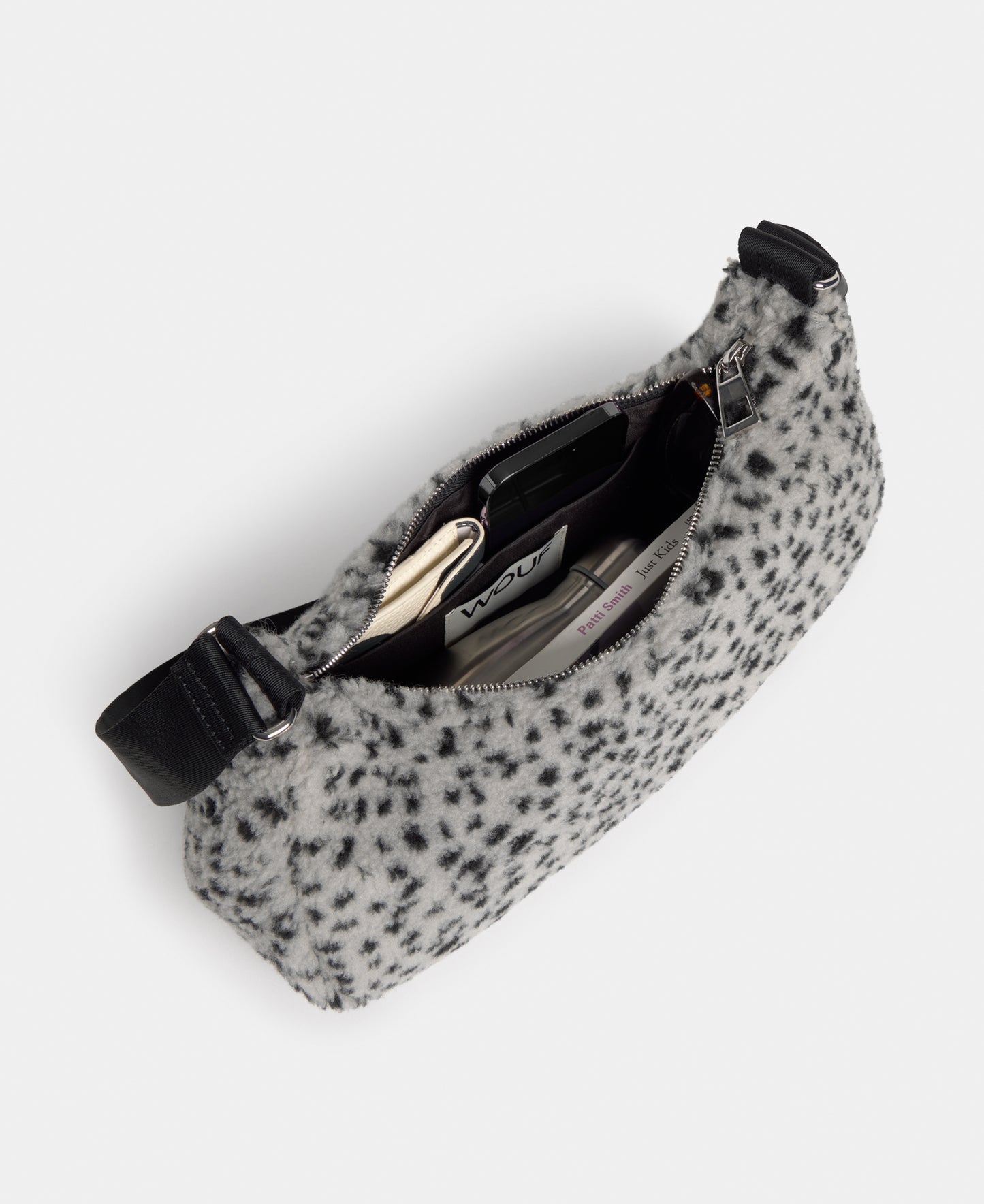 Interior of the crossbody bag in teddy fabric with black micro print on a grey background - Wouf