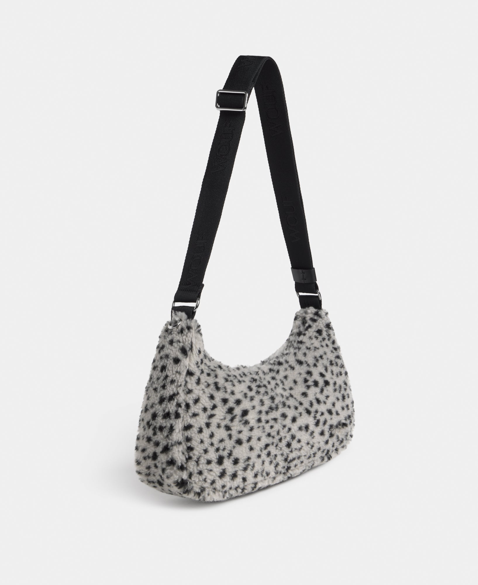Side view of the crossbody bag in teddy fabric with black micro print on a grey background - Wouf