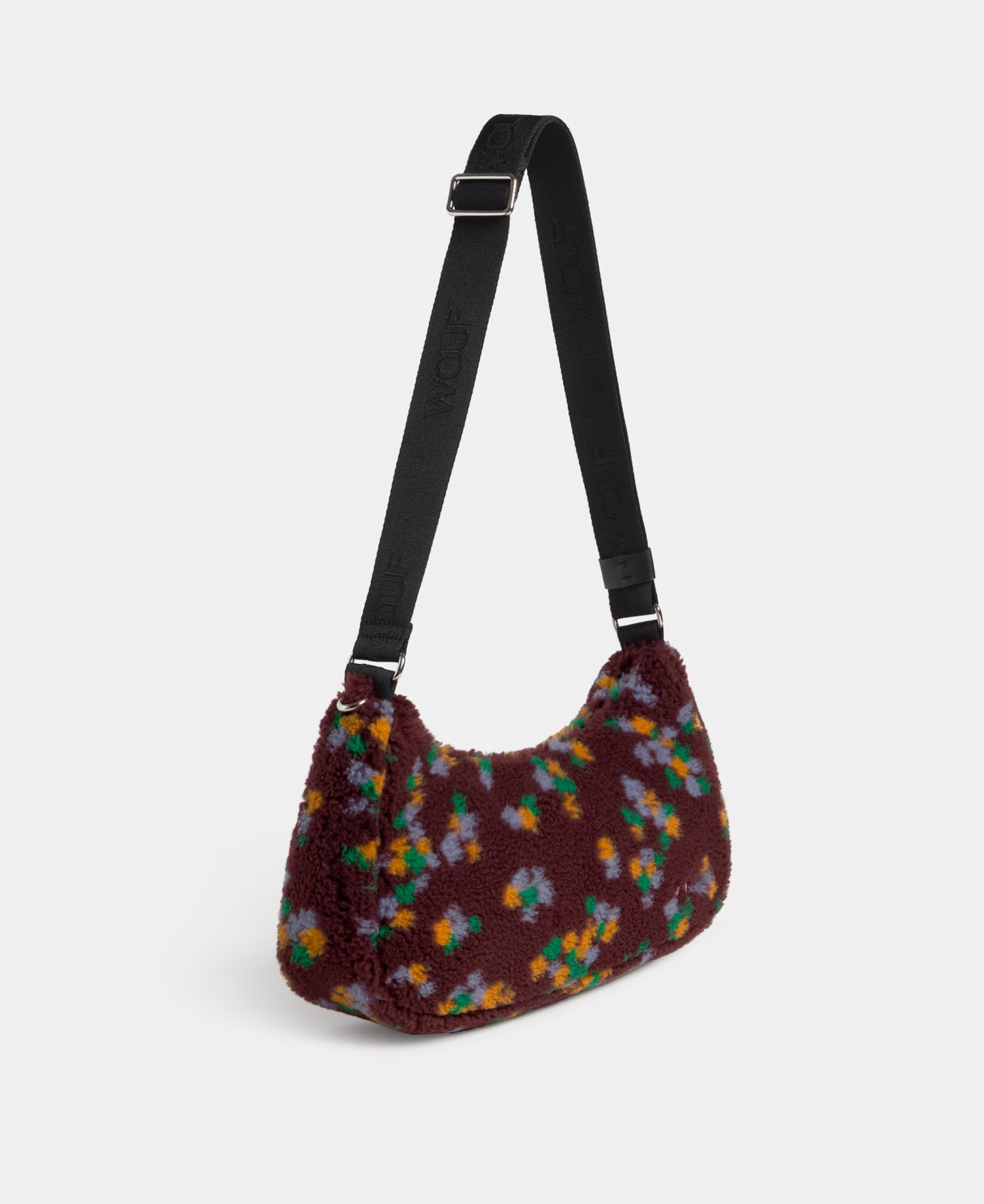 Side view of the crossbody bag in teddy fabric with multicolour floral print on a burgundy background - Wouf