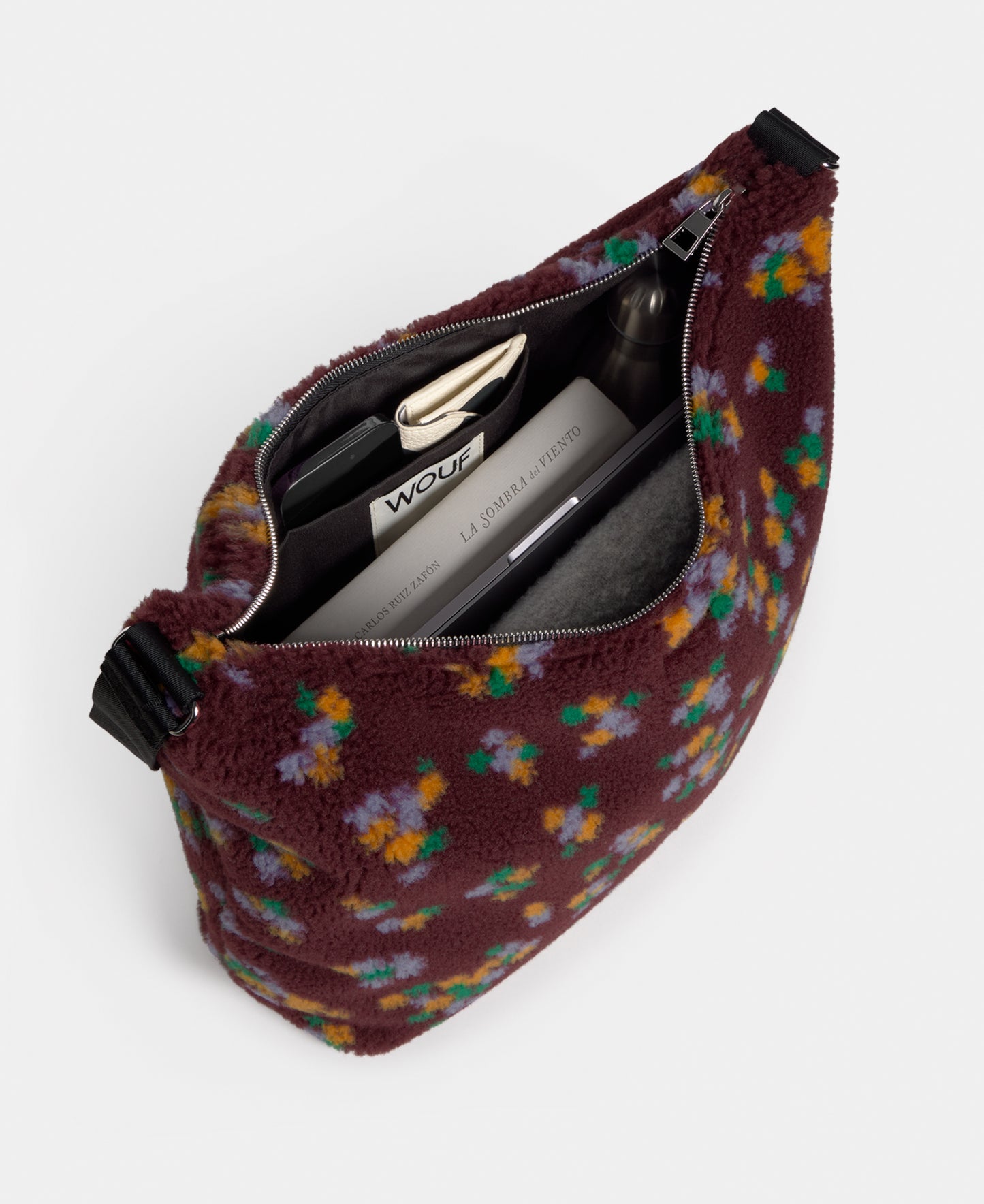 Interior of the hobo bag in teddy fabric with multicolour floral print on a burgundy background - Wouf