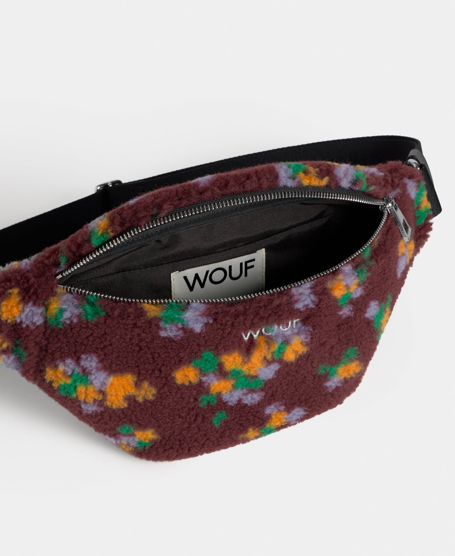 Back view of the waistbag in teddy fabric with multicolour floral print on a burgundy background - Wouf