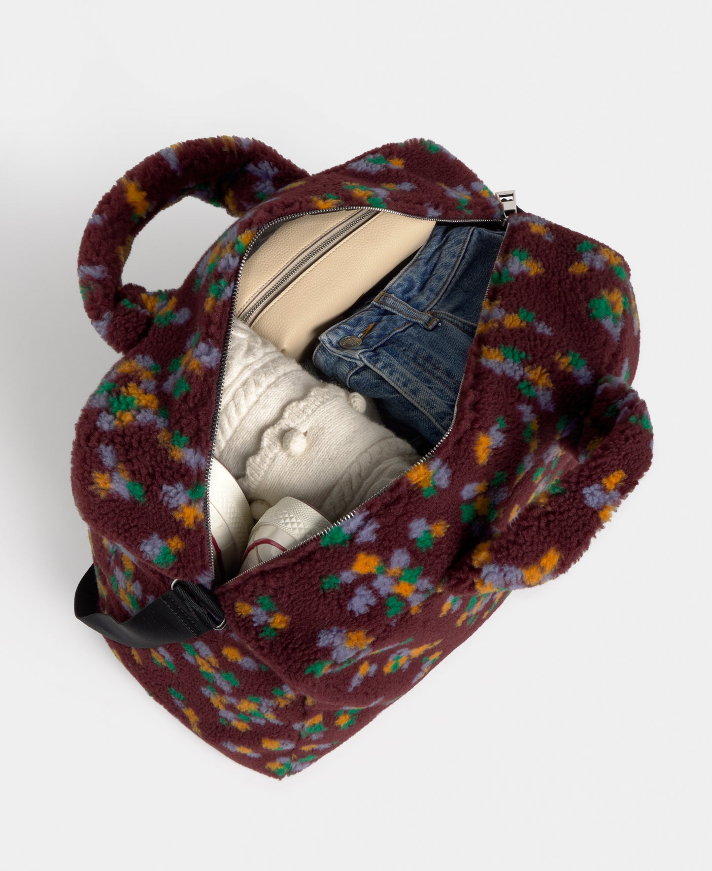 Interior of the weekend bag in teddy fabric with multicolour floral print on a burgundy background - Wouf