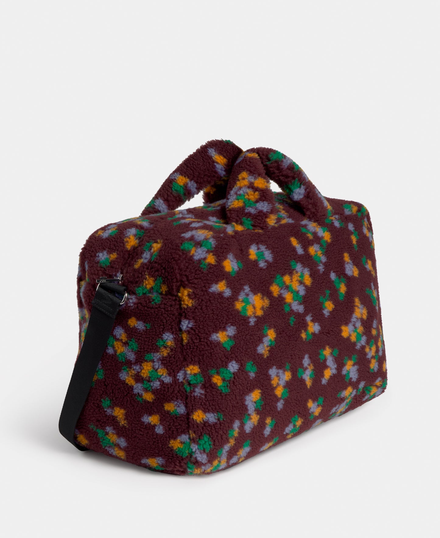 Side view of the weekend bag in teddy fabric with multicolour floral print on a burgundy background - Wouf